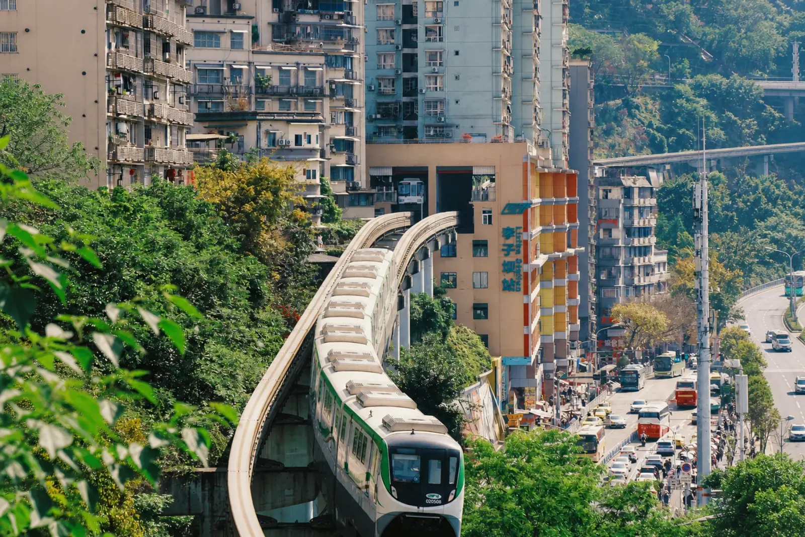 Chongqing monorail train passing through Liziba Station building