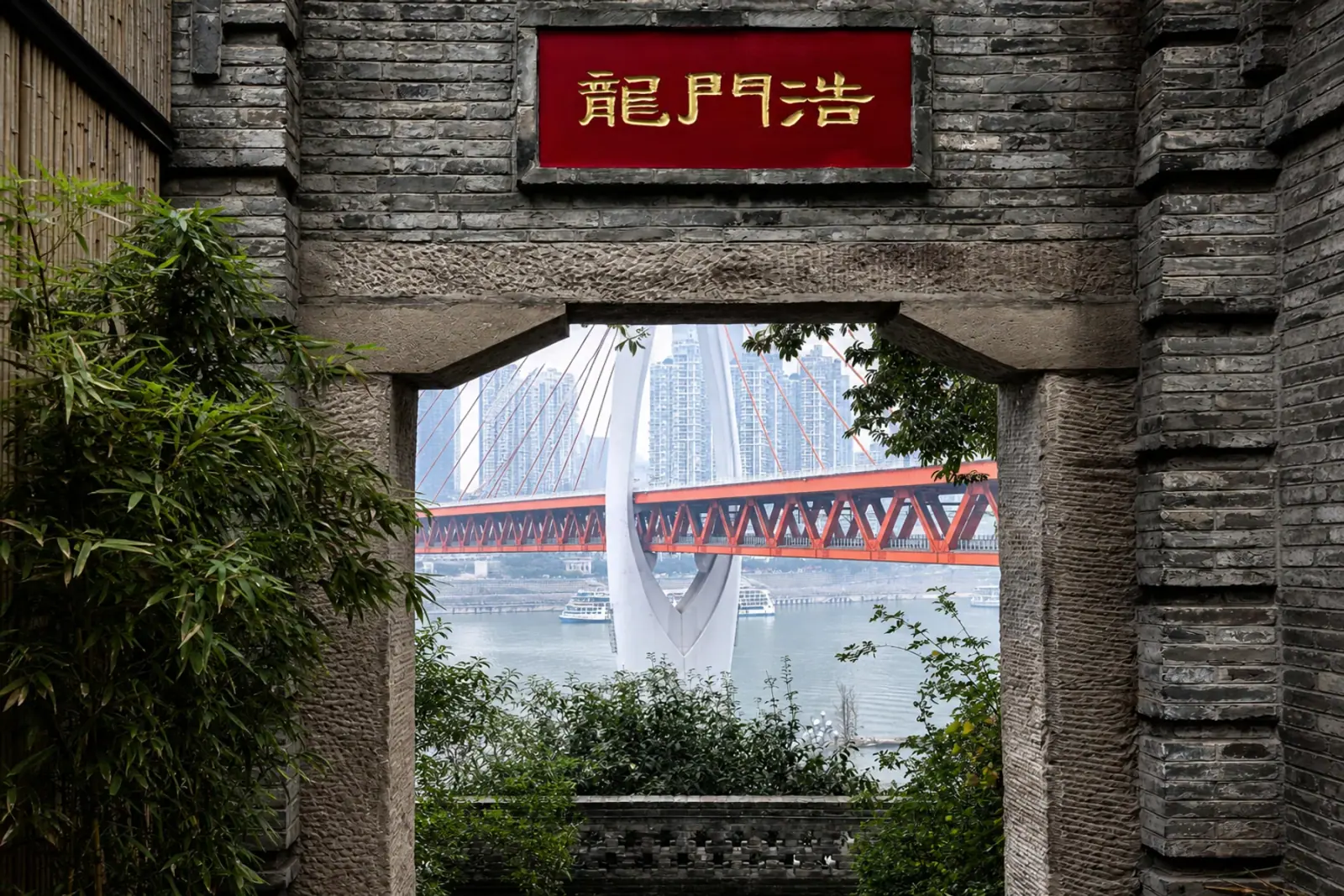 Longmenhao gateway framing Dongshuimen Bridge and the river in Chongqing